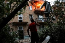 A resident looks at the site of an apartment building hit during Russian missile and drone strikes in Kyiv, Ukraine, on July 31.  Thomas Peter/Reuters Anchorage, Alaska —
