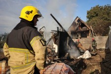 Firefighters work at the site of a Russian missile strike in the village of Sknyliv, on the outskirts of Lviv, Ukraine, early Thursday. (Roman Baluk/Reuters)