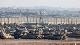 Israeli tanks and military vehicles in Southern Israel on Tuesday, as well as destroyed parts of Gaza as seen from the border.Source: Associated Press