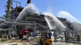 Russian firefighters try to put out a blaze caused by a drone strike at the Novoshakhtinsk oil processing plant in the Rostov-on-Don region in Russia, on June 22, 2022. © AP illustration picture