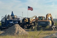 An American flag flies above a piece of heavy machinery at the site of Hyundai Motor Group's electric vehicle plant in Ellabell, Georgia, on Friday. Russ Bynum/AP