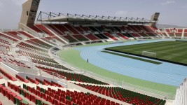 A caretaker walks near the pitch of Fez Stadium in Morocco's central northern city of Fez on June 16, 2025 © Abdel Majid Bziouat, AFP