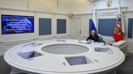 A broadcast from northern Russia showed Vladimir Putin at a circular desk monitoring the launch of an intercontinental missile,(Alexander Kazakov, Sputnik, Kremlin Pool Photo via AP)