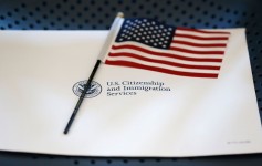 FILE - An information packet and an American flag are placed on a chair at the U.S. Citizenship and Immigration Services Miami Field Office on Aug. 17, 2018, in Miami.  Wilfredo Lee/AP