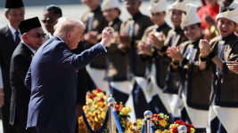President Donald Trump reacts to dancing performers during a welcoming ceremony after arriving at Kuala Lumpur International Airport, to attend the 47th Association of Southeast Asian Nations summit in Malaysia, Sunday, Oct. 26, 2025. (AP)