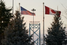 Canadian and American flags fly on the Canadian side of the Ambassador Bridge in Windsor, Ontario, on March 8. Geoff Ronins/AFP/Getty Images