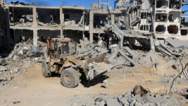 Heavy machinery removes debris from a street in Gaza City amid a ceasefire between Israel and Hamas on Tuesday. (Dawoud Abu Alkas/Reuters)