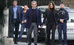 Former French President Nicolas Sarkozy and his wife Carla Bruni-Sarkozy leave their home in Paris on October 21, 2025. © Thibault Camus, AP