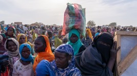 Des femmes se partagent les rations données tous les deux mois par le Programme alimentaire mondial au «site improvisé» d'Adré, qui accueille 237 000 réfugiés soudanais.  Photo : Radio-Canada / Frédéric Lacelle