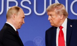 U.S. President Donald Trump and Russian President Vladimir Putin look at each other during a press conference following their meeting to negotiate an end to the war in Ukraine, at Joint Base Elmendorf-Richardson, in Anchorage, Alaska, August 15, 2025. 