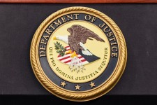 The Department of Justice logo is seen on a podium during a press conference at the U.S. Attorney's Office, Oct. 23, 2025, in New York. Angelina Katsanis/AP