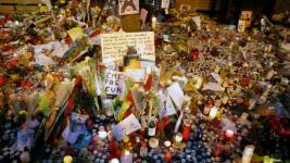 Flowers, pictures and candles are set in memory outside La Belle Equipe restaurant in Paris, one of the locations attacked, November 17, 2015. © Francois Mori, AP