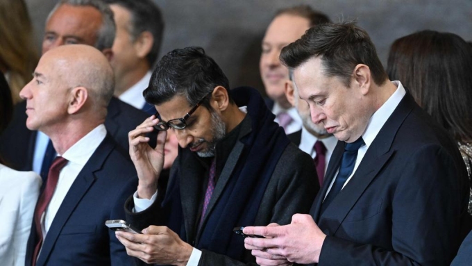 Google chief executive Sundar Pichai (centre) has warned America risks losing the AI race to China unless it streamlines regulations. Picture: AFP