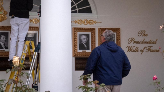 Workers installing the plaques along the “walk of fame”. Hey, a pay cheque is a pay cheque. Picture: Mark Schiefelbein/AP