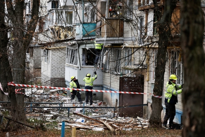 Emergency responders work at the site of a Russian drone strike on an apartment building in Kyiv, Ukraine, on Dec. 23, 2025. Thomas Peter/Reuters