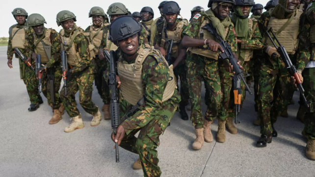 Kenyan police officers, part of a gang suppression force, sing and dance on the tarmac after landing at Toussaint Louverture International in Port-au-Prince, Haiti. © Odelyn Joseph, AP