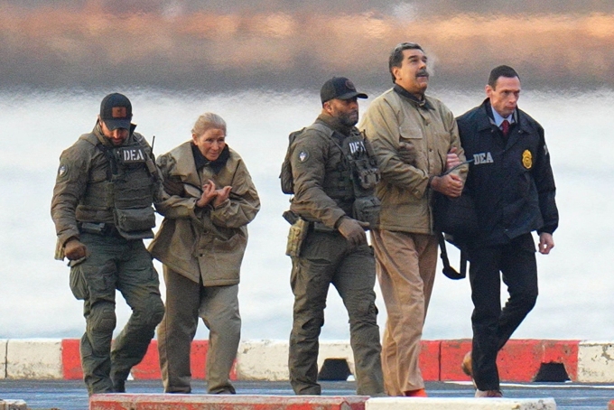 Nicolas Maduro and his wife Cilia Flores are seen in handcuffs after landing at a Manhattan helipad, on their way to a federal courthouse in the Manhattan borough of New York on January 5, 2026.  XNY/Star Max/GC Images/Getty Images