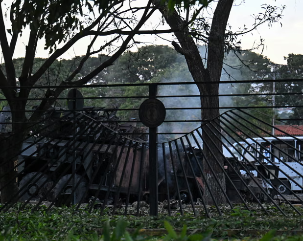 A burnt-out vehicle is seen at La Carlota airbase in Caracas, 3 January. Photograph: Juan Barreto/AFP/Getty