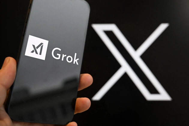 A smartphone bears the logo of Grok, a generative artificial intelligence chatbot from xAI in front of the X logo on Jan. 12, 2026. | Nicolas Tucat/AFP via Getty Images