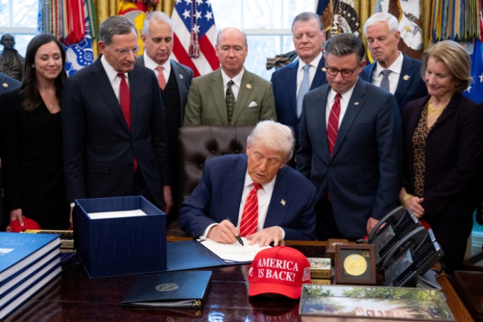 President Trump signs the funding bill in the Oval Office. Saul Loeb/AFP/Getty Images