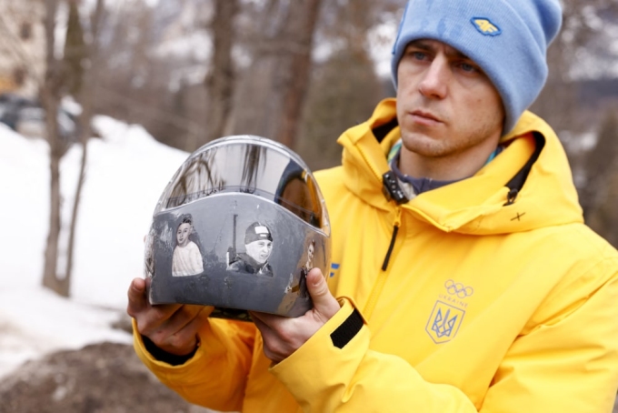 Ukraine's skeleton racer Vladyslav Heraskevych holds his helmet, which depicts victims of his country's war with Russia, in Cortina d'Ampezzo.Odd Andersen / AFP - Getty Images