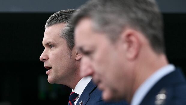 U.S. Secretary of War Pete Hegseth, left, and the Chairman of the Joint Chiefs of Staff Gen. Dan Caine speak during a news conference at the Pentagon today. (Brendan Smialowski/AFP/Getty Images)