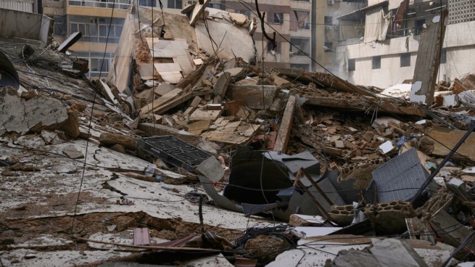 Debris litters a street from buildings damaged in an Israeli airstrike in Dahiyeh in the Lebanese capital Beirut's southern suburbs on Monday. (Bilal Hussein/The Associated Press)