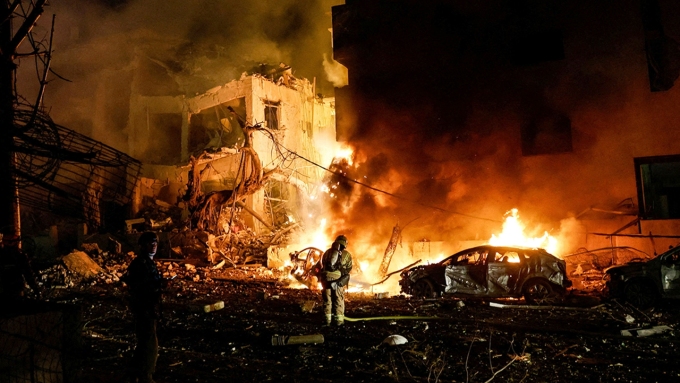 Israeli firefighters work to put out a fire on a car at the site of a projectile impact after Iran launched missiles into Israel, in Tel Aviv, Israel, Feb. 28. (Tomer Appelbaum/Reuters)