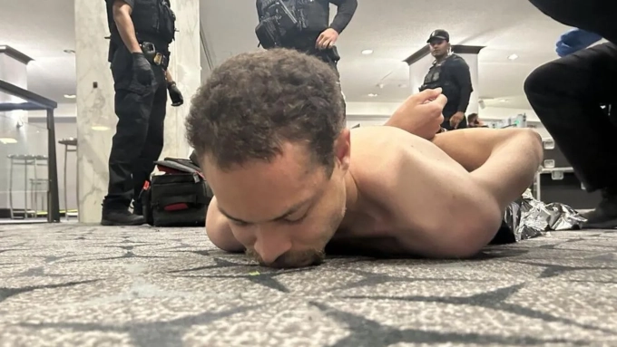@REALDONALD TRUMP / TRUTHSOCIAL President Trump shared this photo appearing to show the shirtless suspect on the floor of the Washington Hilton hotel
