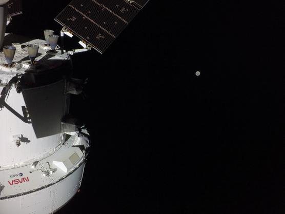 This handout picture provided by NASA shows the Orion spacecraft with the Moon in the distance, as captured by a camera on the tip of one of its solar array wings, on April 3, 2026. NASA / AFP