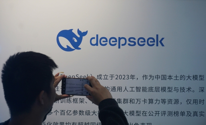 A citizen is watching a display board about DepSeek AI big model in a shopping mall in Hangzhou, Zhejiang Province, China on April 23, 2026.  CFOTO/Future Publishing/Getty Images