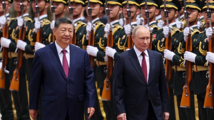 The two leaders walked down the red carpet to the centre past a line of troops. Picture: Maxim Shemetov/Pool Photo/AP