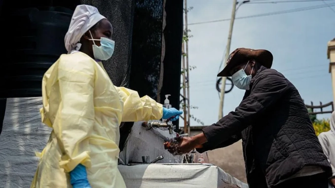 Jospin Mwisha / AFP via Getty Images. All visitors and patients must wash their hands and have their temperatures taken before entering Kyeshero Hospital in Goma
