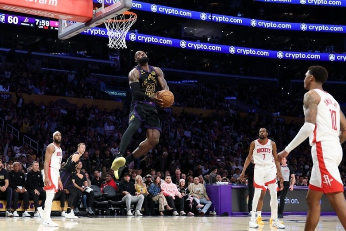 LeBron James goes up for a windmill dunk during Game 2 of the Lakers' playoff series against the Rockets. Robert Gauthier / Los Angeles Times via Getty Images