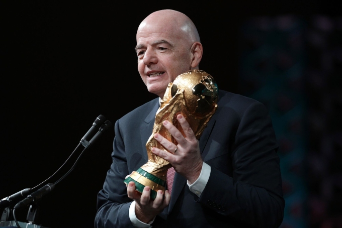 FIFA President Gianni Infantino holds the FIFA men's World Cup Trophy as he addresses the winter meeting of the US Conference of Mayors on January 29 in Washington, DC.  Alex Wong/Getty Images