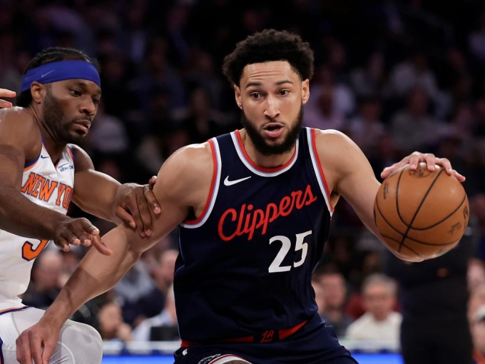 Ben Simmons drives past New York Knicks forward Precious Achiuwa. AP Photo/Adam Hunger.