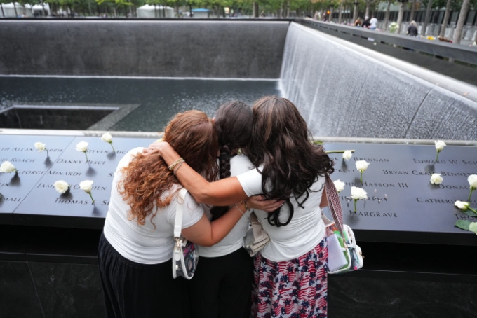 Three women at the 9/11 Memorial in New York City on Friday. Adam Gray/PRESS Pool