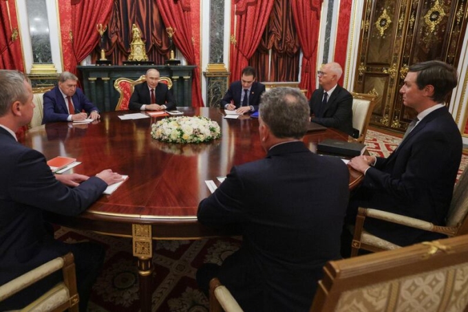 President Vladimir Putin, background centre left, speaks at a meeting with U.S. envoys at the Kremlin on Saturday. (Gavriil Grigorov/Sputnik/The Associated Press)