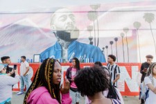 Fans come to take pictures and pay their respects in front of murals of Nipsey Hussle. Photograph: Alex Welsh/The Guardian