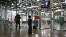 Image copyrightGETTY IMAGES Image caption A boy from Honduras watches a movie at a detention facility