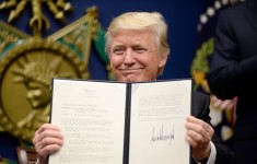 President Trump after signing the original travel ban on Jan. 27, 2017.CreditPool photo by Olivier Douliery