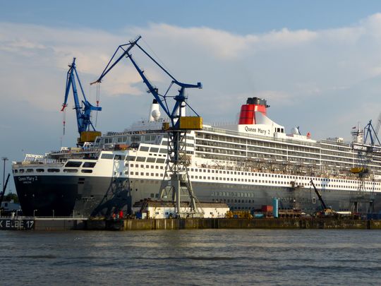 Massive cranes on either side of the dry dock in Hamburg hoisted 300 containers' worth of new carpeting, textiles, furniture and other supplies onto the ship. (Photo: Peter Knego)