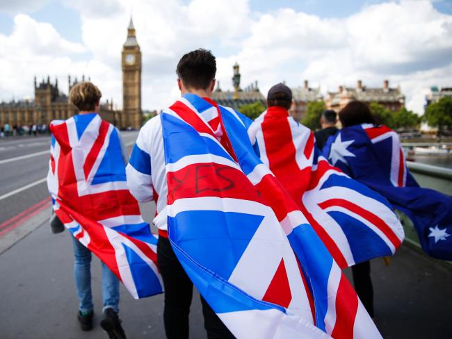 People walk over Westminster Bridge wrapped in Union flags after the referendum. Picture: AFP/Odd AndersenSource:AFP