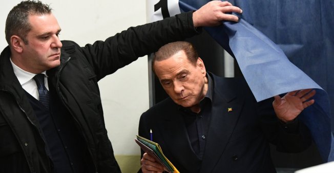 © Miguel Medina / AFP | Silvio Berlusconi exits the polling booth after castinhis vote in Italy's general election on on March 4, 2018.