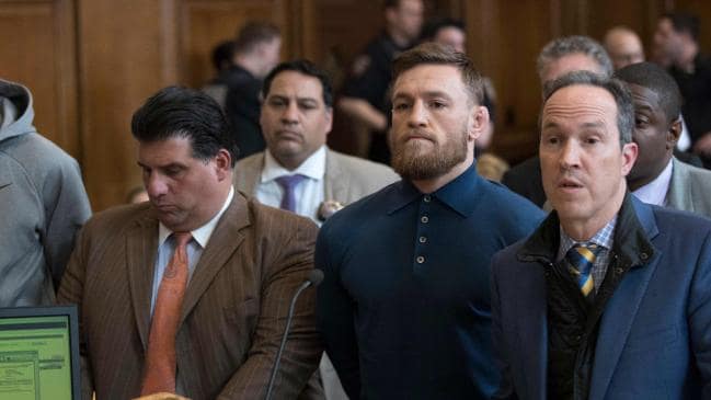 Irish Mixed Martial Arts fighter Conor McGregor (2R) looks on next to his lawyer Jim Walden (R) and John Arlia (2L) during his arraignment at the Brooklyn Court on April 6, 2018 in New York. . / AFP PHOTO / POOL �