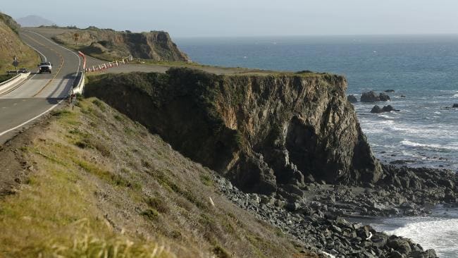 A truck drives by the cliff where the Harts’ SUV was recovered off the Pacific Coast Highway, near Westport, California. Picture: Alvin Jornada/The Press Democrat via APSource:AP