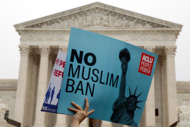 REFILE - CORRECTING STYLE Protesters rally outside the U.S. Supreme Court, while the court justices consider case regarding presidential powers as it weighs the legality of President Donald Trump&#39;s latest travel ban targeting people from Musl