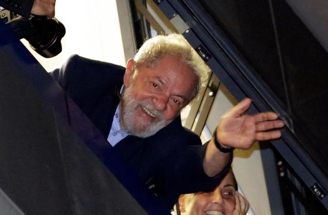 Brazil's former President Luiz Inacio Lula da Silva waves to supporters in front of the metal workers union headquarters in Sao Bernardo do Campo, Brazil, ...