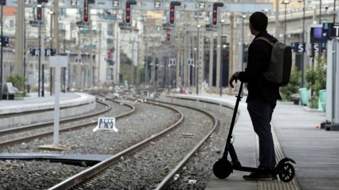 Commuter in Nice  / REUTERS Image caption A commuter ponders his options at Nice station