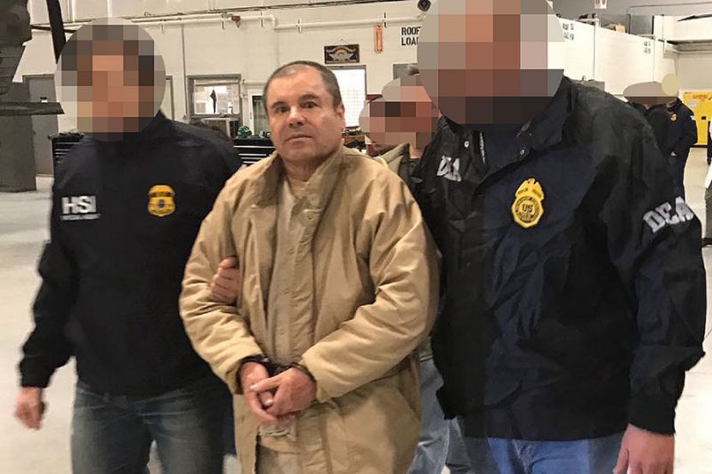 This handout picture released by the Mexican Interior Ministry on January 19, 2017 shows Joaquin Guzman Loera aka "El Chapo" Guzman (C) escorted in Ciudad Juarez by the Mexican police as he is extradited to the United States (AFP Pho